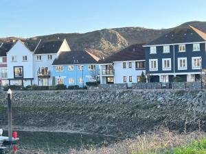 a row of houses with mountains in the background at Abba House in Llandudno