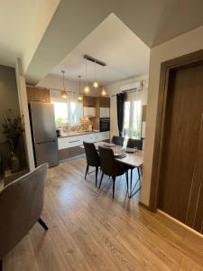 a kitchen and dining room with a table and chairs at Luxurious/Modern Vacation Home (Clair De Lune) in Ágios Matthaíos