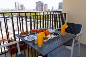a table with a plate of food on a balcony at Havana View hotel in Erbil +16 photos