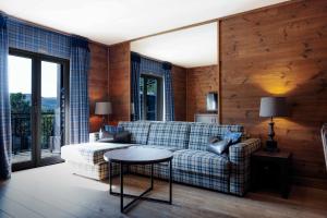 a living room with a couch and a table at Vestlia Resort in Geilo +66 photos
