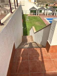 a stairway leading up to a patio with a pool at MH38 - Apartment with wonderful sea views in Murcia