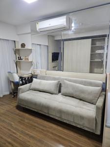 a living room with a couch in a room at Flat vista mar Boa Viagem in Recife