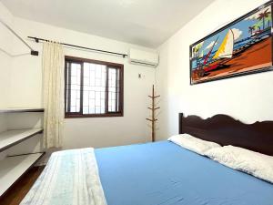 A bed or beds in a room at Espaço Família - Perto da praia e Beto Carrero
