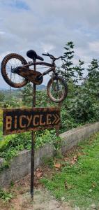 a bike on top of a sign in the grass at Bicycle House in Felgueiras