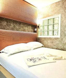 a bedroom with a large white bed with a window at Orsay - Beautiful flat in elegant part of Paris in Paris