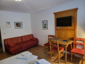 a living room with a couch and a table at Gasthof Ramona in Scharnitz