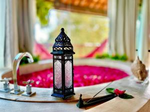 a figurine of a candle on a table at BANGATACHO - Bangalôs Temáticos na Praia do Patacho - Milagres in Pôrto de Pedras