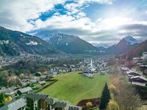 a small town in a valley with mountains at Chalet Figue in Morzine
