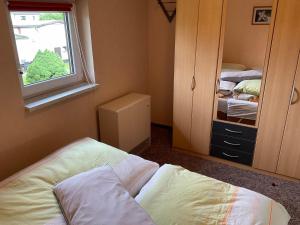 a small bedroom with a bed and a window at Lorisch 3 - 1 Etage - ABC339 in Hornstorf