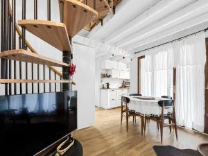 a living room with a table and chairs and a staircase at Refuge Montagnard - Terrasse et Local à Ski ou Vélo in Ax-les-Thermes +16 photos