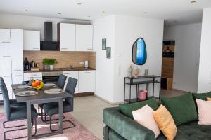 a living room and kitchen with a table and a couch at Auszeit in Radolfzell in Radolfzell am Bodensee +29 photos