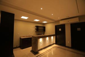 a large room with a kitchen with a counter top at Munir`s residence 2 in Cairo