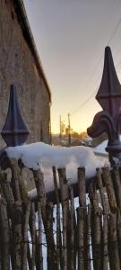 a fence with snow on top of it at La Petite Taupe in Saint-Omer
