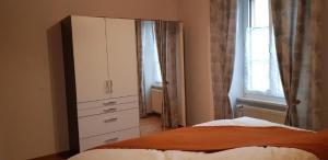 a bedroom with a large white cabinet and a bed at Ferienwohnung Gte rural in Courcelon