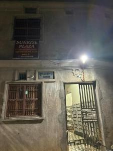 a building with a door and a window and a street light at Sunrise Plaza ( ठहरने का उत्तम प्रबंध) in Deoghar