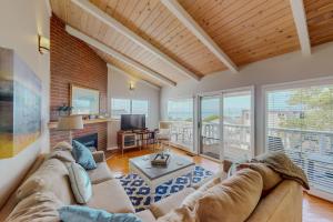 a living room with a couch and a tv at Awesome Views in Cambria
