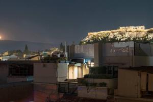 a view of a city at night with a mountain at Hoppersgr- Amazing apt in the heart of Athens - 6 in Athens