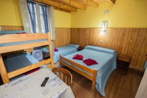 a room with two bunk beds and a table at Alma Alquimia in Valle Hermoso +37 photos