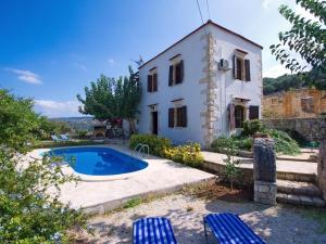 a house with a swimming pool in front of it at Villa Ovgoro, Provarma, pool, seaview balcony in Próvarma