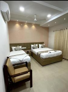 a bedroom with two beds and a wall at GREEN TERRUS BUSINESS CLASS HOTEL in Chennai