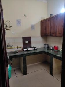 a kitchen with a counter top with a sink and a counter sidx sidx at Shri Achyutam Villas in Vrindāvan