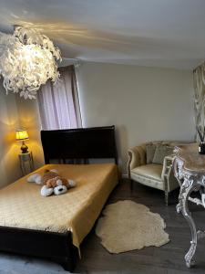 a bedroom with a bed with a stuffed animal on it at Cosy apartment in Kaunas