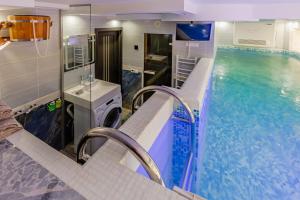 a bathroom with a swimming pool and a sink at Luxury Apartment with Pool and Hammam in Kyiv