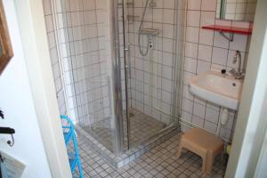 a bathroom with a shower and a sink at Heggerank 66* in Nieuwvliet +22 photos
