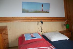 a small room with a bed and a light house at Heggerank 66* in Nieuwvliet