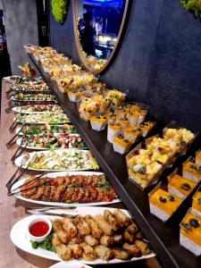 a buffet line with many different types of food at My Story Gdynia Hotel in Gdynia
