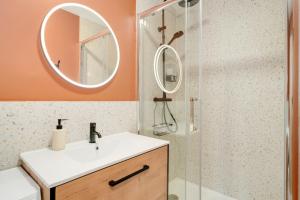 a bathroom with a sink and a shower with a mirror at L'Elégance du centre - Nancy Gare Congrès - PARKING - T3 in Nancy +33 photos
