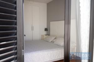a bedroom with a bed and a mirror at VILLA BERMEJA 20 by Villitas in Playa Blanca