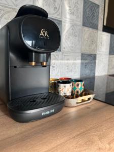 a coffee maker sitting on top of a table at L'Elégance du centre - Nancy Gare Congrès - PARKING - T3 in Nancy