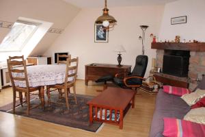 a living room with a table and a dining room at 655 - Appartement à Erquy, en centre bourg à 300m de la plage du centre in Erquy