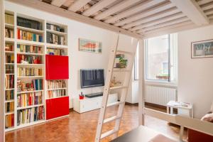 a room with bookshelves and a loft bed at Lovely Private Room in Milan