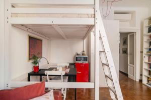 a loft bed with a desk in a room at Lovely Private Room in Milan