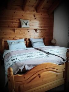 een houten bed in een slaapkamer met een houten muur bij 3 12 Zimmer Duplex Ferienwohnung Moosalpe A in Bürchen