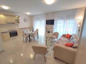 a living room and kitchen with a couch and a table at Studio in Siofok - Balaton 45328 in Siófok