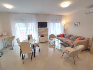 a living room with a couch and a table and chairs at Studio in Siofok - Balaton 45328 in Siófok