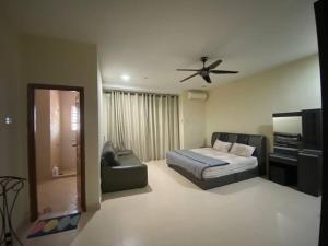 a bedroom with a bed and a ceiling fan at SOFEA HOMESTAY Islam sahaja in Seremban