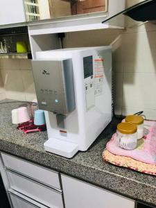 a microwave sitting on a counter in a kitchen at SOFEA HOMESTAY Islam sahaja in Seremban