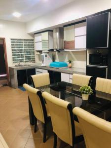 a kitchen with a table and chairs in a room at SOFEA HOMESTAY Islam sahaja in Seremban