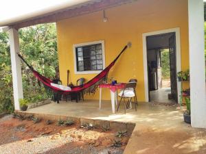 a hammock on the porch of a house at Chalé dos Lírios in Alto Paraíso de Goiás