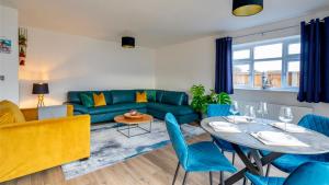 uma sala de estar com um sofá azul e uma mesa em The Beach House with Balcony North Wales em Kinmel Bay