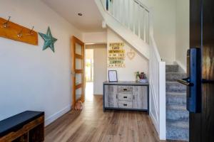 a hallway with a staircase and a desk in a house at The Beach House with Balcony North Wales in Kinmel Bay