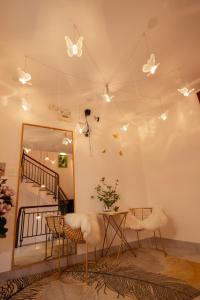 a room with a table and chairs and butterflies on the wall at The Sophia Apartment - Thao Dien Central in Ho Chi Minh City