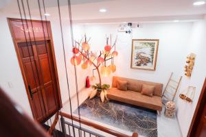 a view of a living room with a couch at The Sophia Apartment - Thao Dien Central in Ho Chi Minh City