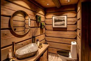 bagno con lavandino e specchio di ElveRo Lodge a Trysil