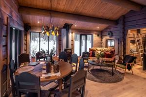 a dining room with a table and a couch at ElveRo Lodge in Trysil