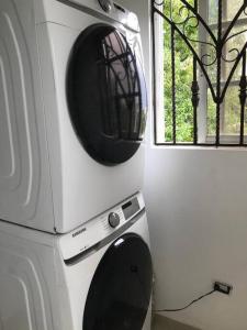 a microwave sitting on top of a stove next to a window at Residencial Joyas D’ Luxe III A3 in Santiago de los Caballeros